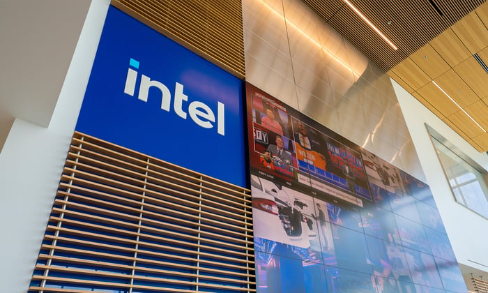 Intel company name on blue background inside a company office.