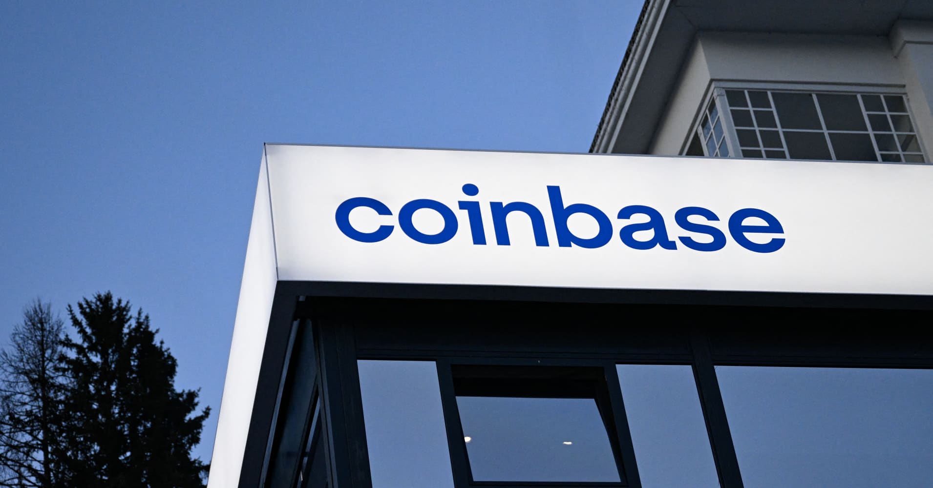 This photograph taken on Jan. 21, 2026 shows signage of the Coinbase logo during the World Economic Forum (WEF) annual meeting in Davos.