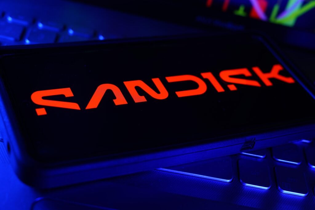 Sandisk Company Logo on Screen with Stock Chart Financial Performance in Background