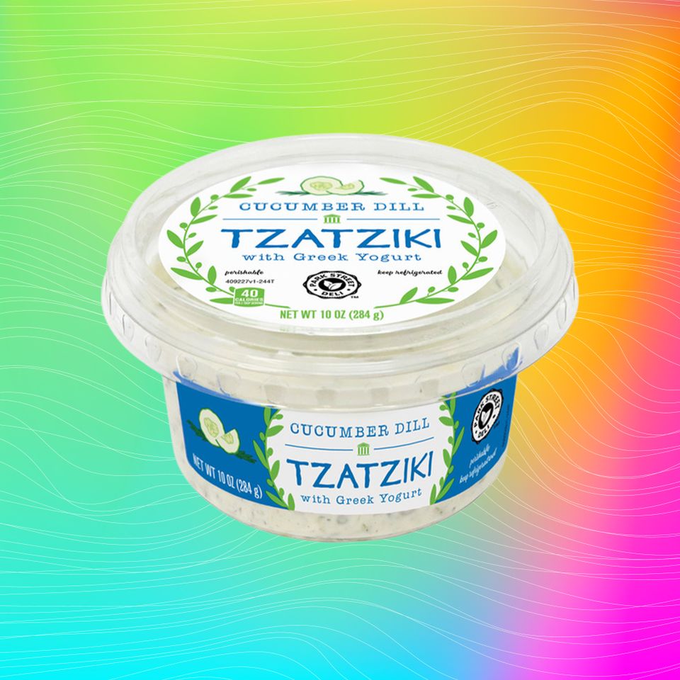 A container of cucumber dill tzatziki with Greek yogurt on a colorful gradient background