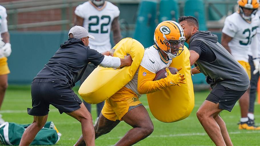 Green Bay Packers running back Josh Jacobs takes part in a ball-security drill.
