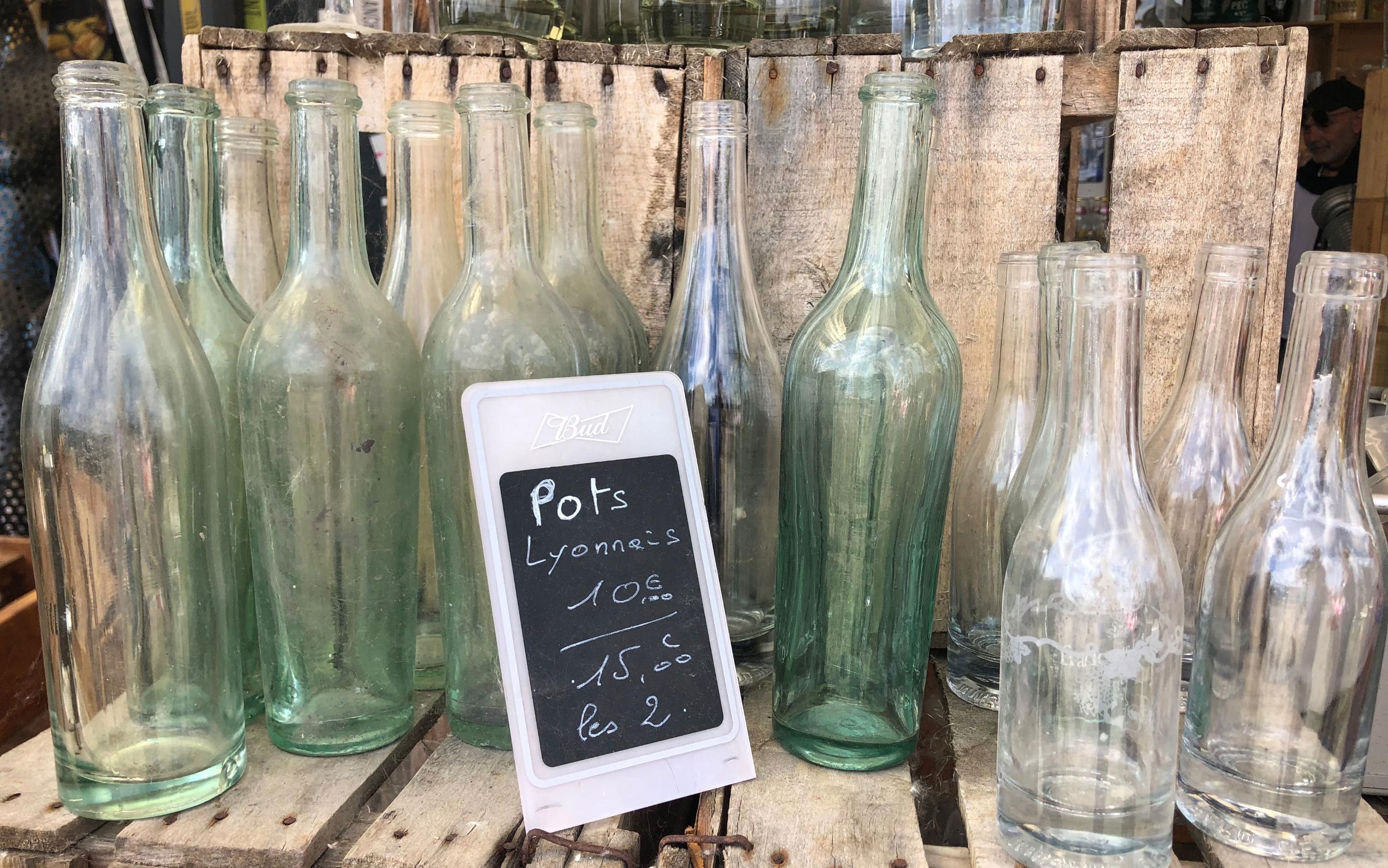 Lyonnais pots (thick-bottomed glass bottle for wine) for sale; best things to do in Lyon