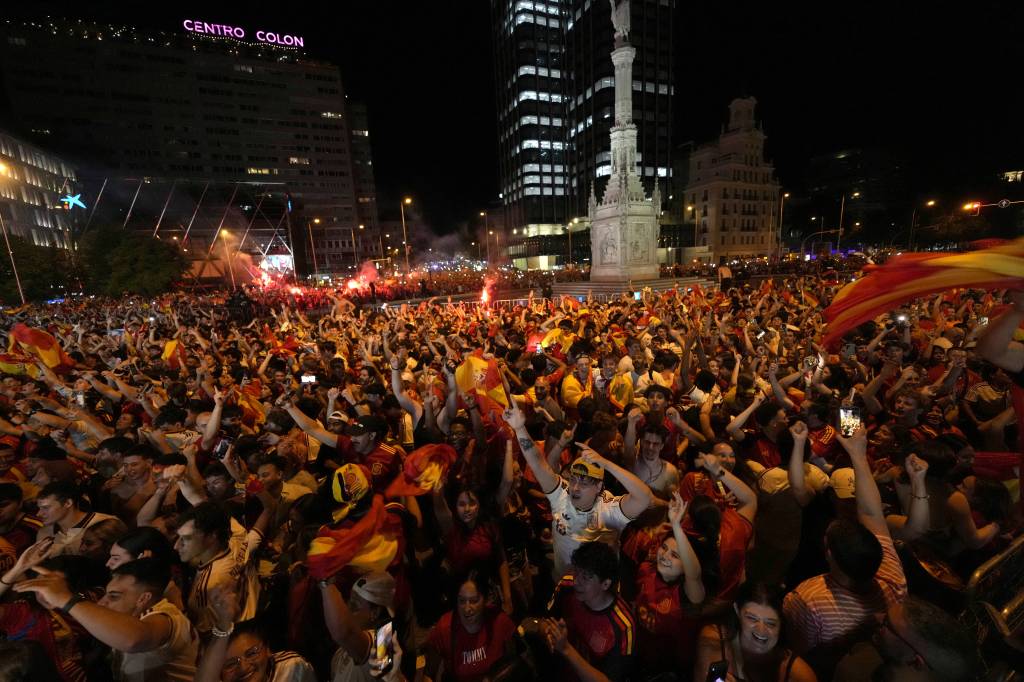 Spain's supporters celebrate victory after the 2026 World Cup final match between Spain and Argentina displayed on giant screens at Colon square's fan zone in Madrid, on July 19, 2026. (Photo by Paul Hanna / AFP via Getty Images)
