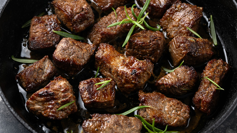 Garlic butter beef steak bites in iron cast pan