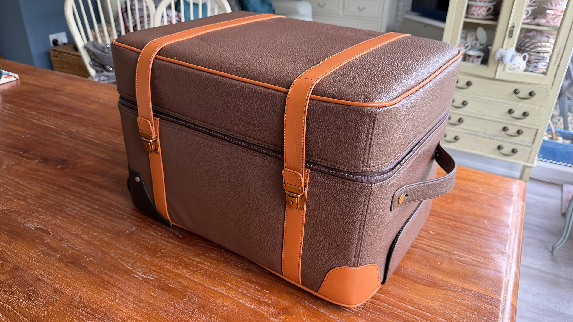Hisense XR10 home cinema projector in carry case on wooden table