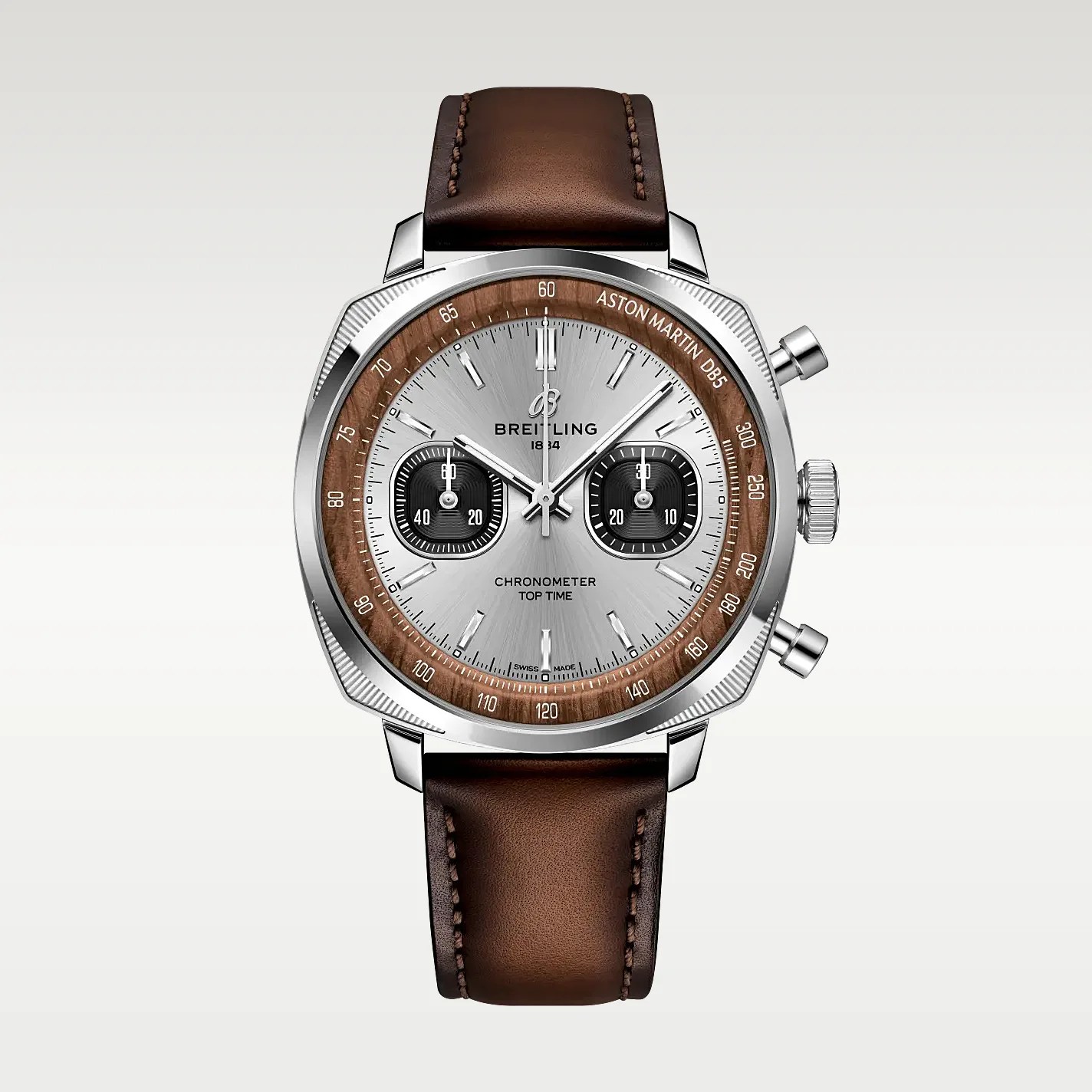 Silver Breitling chronometer watch with brown leather strap and wood-textured bezel marked "Aston Martin DB5.