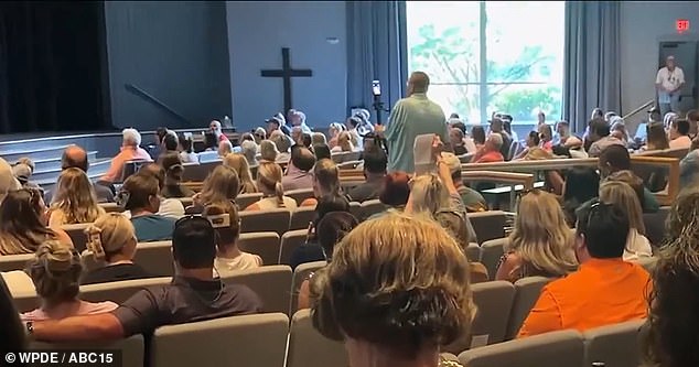 Church and community members are seen at the meeting, they accused the church of failing to let them know Perry was a registered sex offender