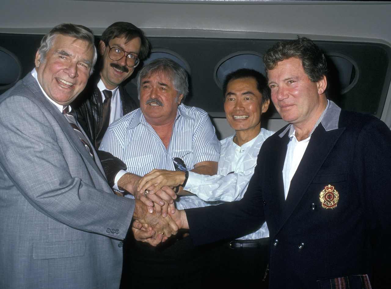 Gene Roddenberry William Shatner George Takei James Doohan group posing together smiling hand gesture visible
