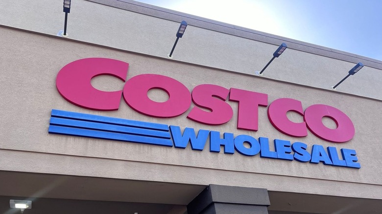 The front entrance to a Costco store with the logo front and center.
