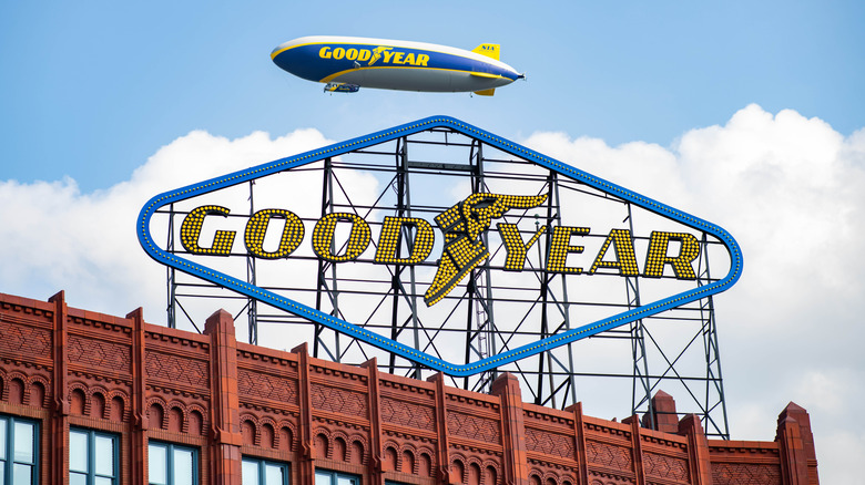 A Goodyear Blimp flying over the company sign in Akron, Ohio