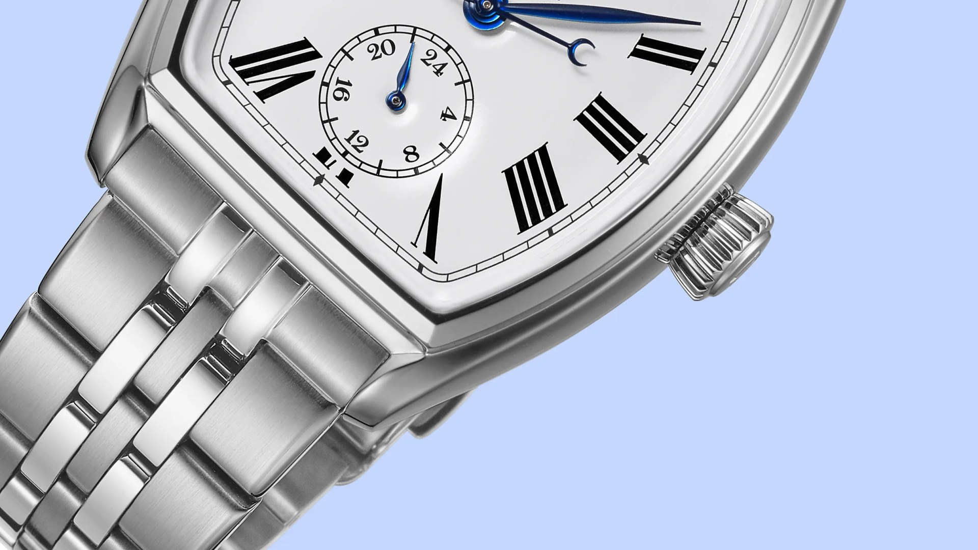 Close-up of a silver metal watch with a white face, black Roman numerals, and blue hands on a light blue background.