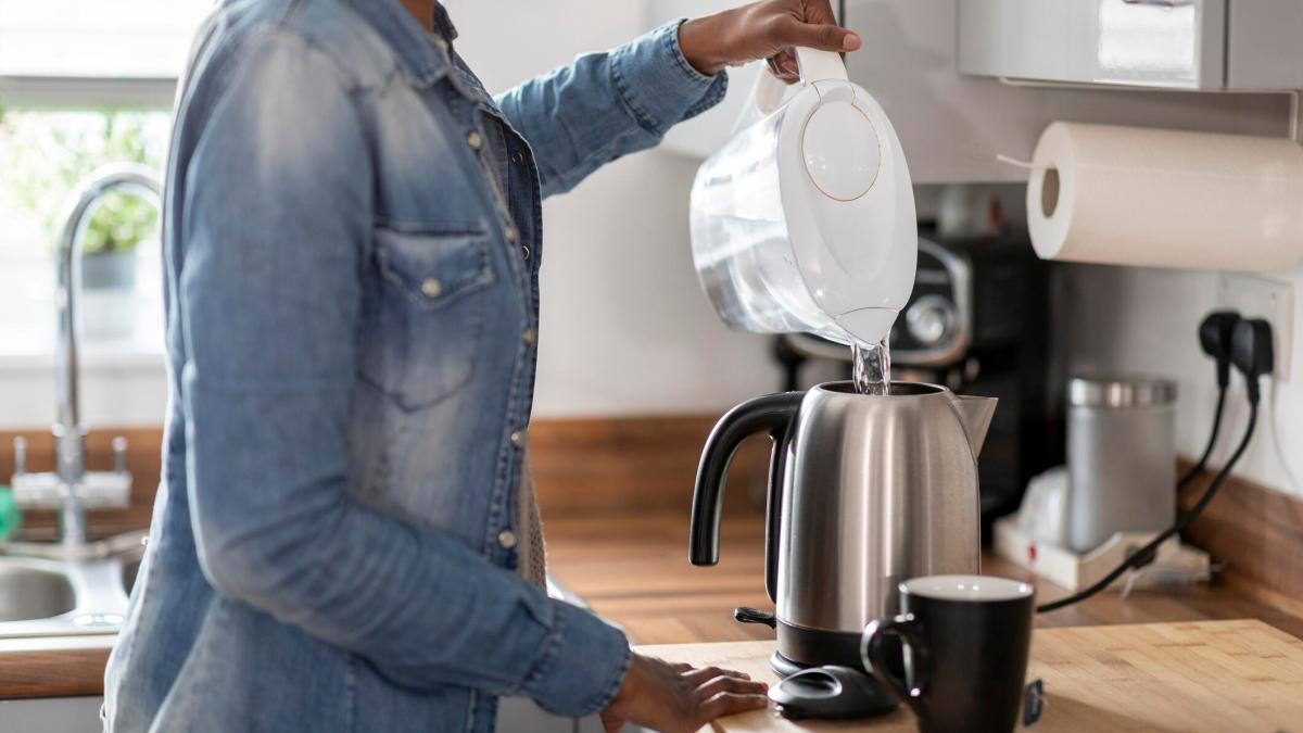 person-pouring-water-filter-pitcher