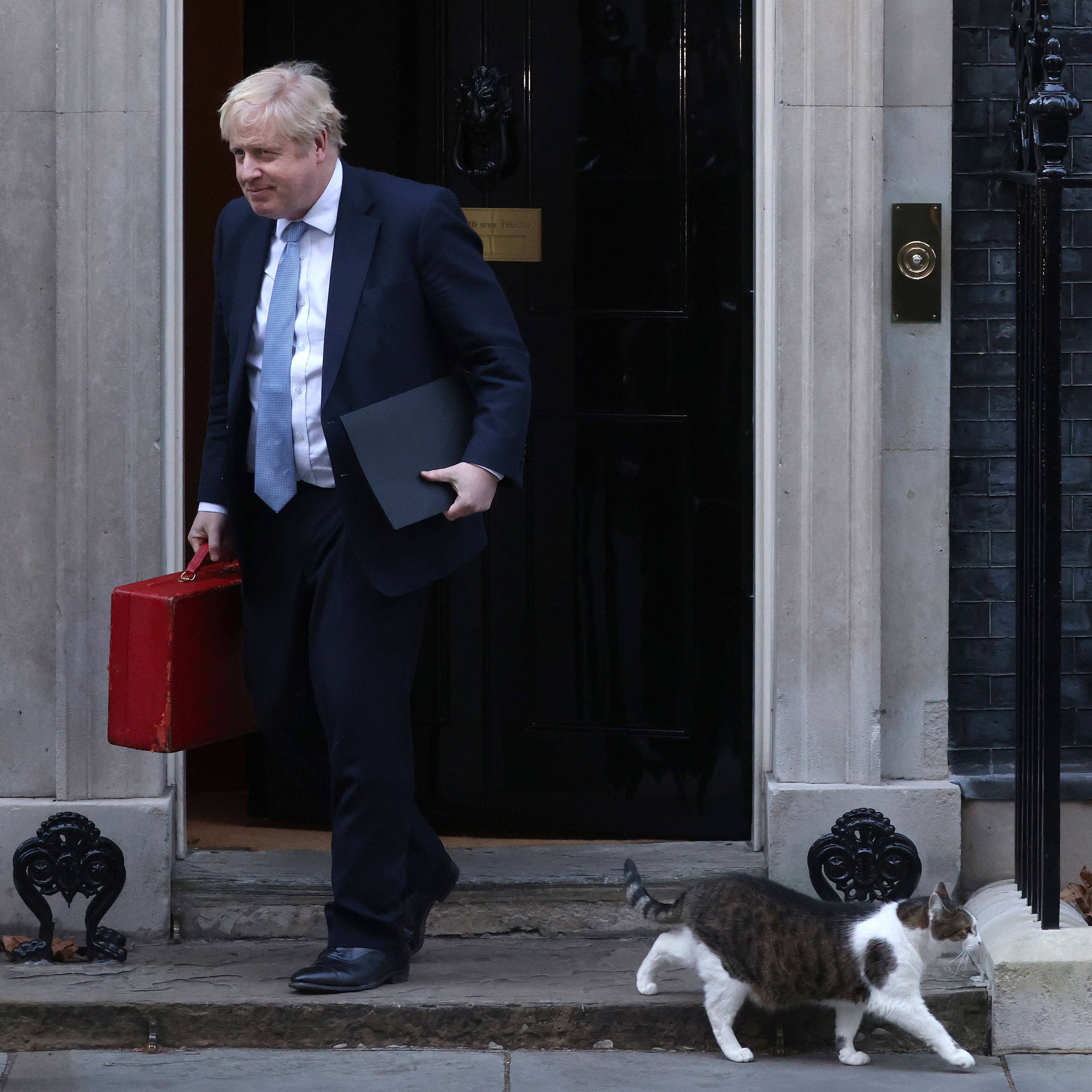 Prime Minister Boris Johnson leaves 10 Downing Street to make a statement at Parliament as Larry the cat walks past on January 31, 2022 in London, England.