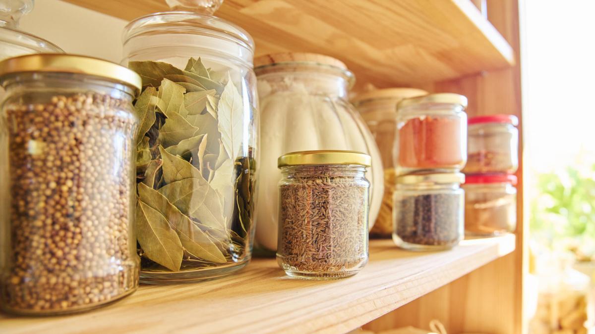 Storage of food in the kitchen in the pantry. Cereals, spices, pasta, nuts, flour in jars and containers, kitchen utensils. Cooking at home, stocking food, household