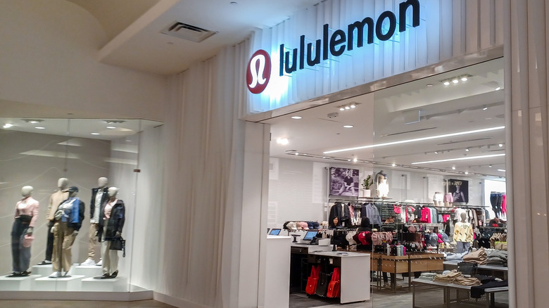 a Lululemon store with mannequins on display outside the entrance