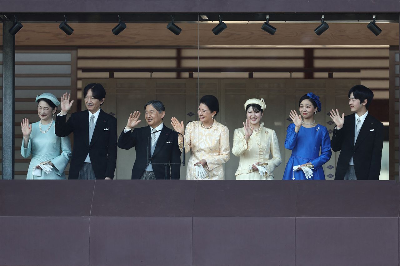 Japan's Emperor Naruhito (3rd L), Empress Masako (C) and their daughter Princess Aiko (3rd R), accmpanied by Crown Prince Akishino (2nd L), Crown Princess Kiko (L), and their second daughter Princess Kako (2nd R), and their eldest son Prince Hisahito (R), wave to visitors during a public audience celebrating the Emperor's 66th birthday, at the Imperial Palace in Tokyo on February 23, 2026.