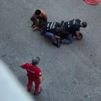 A screengrab from amateur video shared widely on social media, including by the family of Moroccan-born Italian Abderrahim Fakir, shows him being held down by two police officers and a third man on July 19, 2026 in Bologna, Italy, during an attempted arrest that ended with his death.