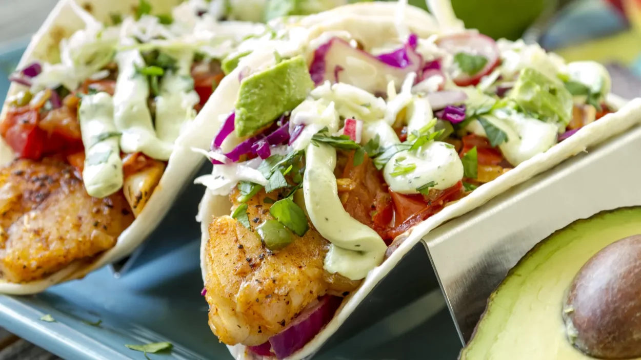 Making baked fish tacos with avacado.