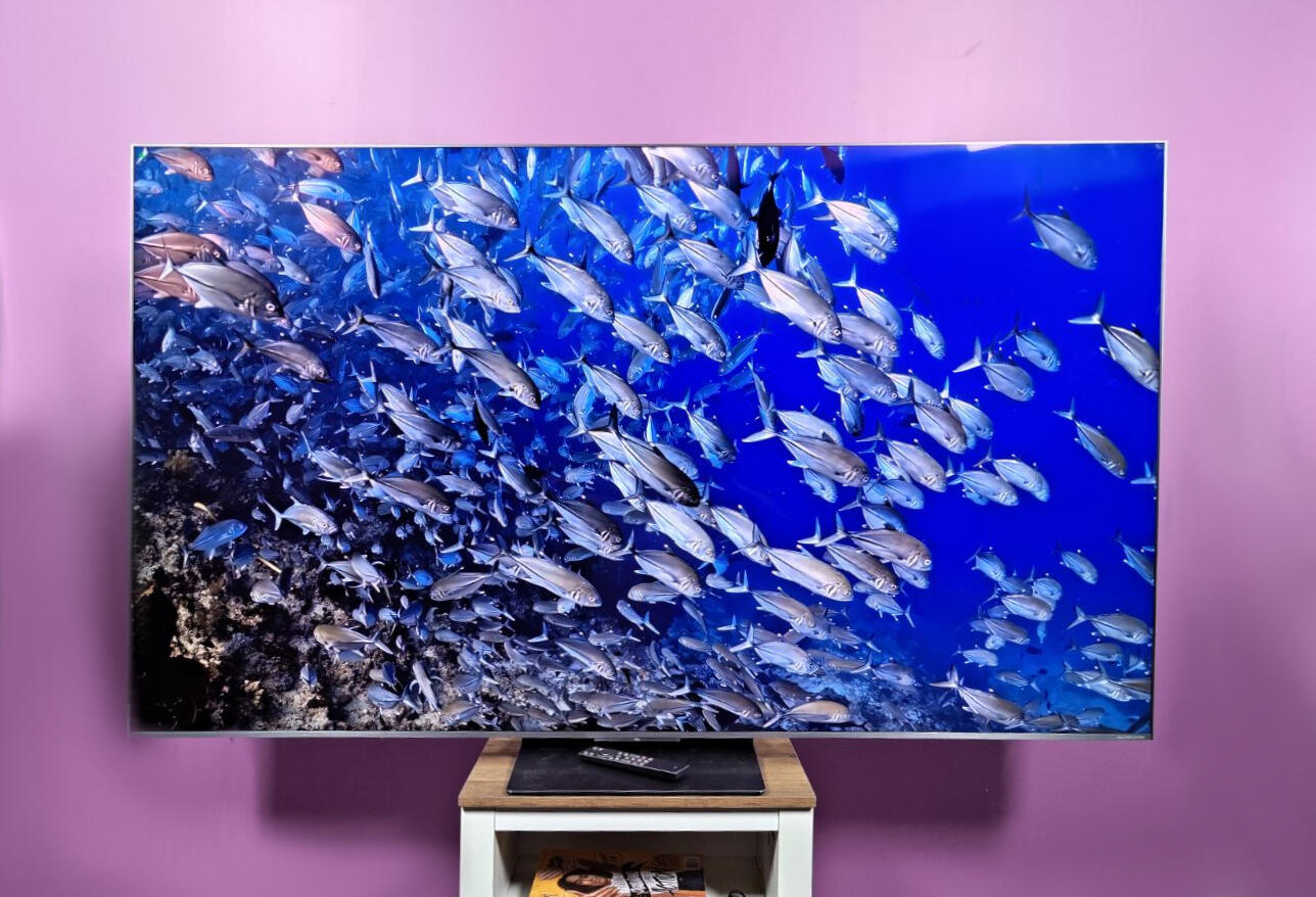 TCL QM8L TV against a purple wall