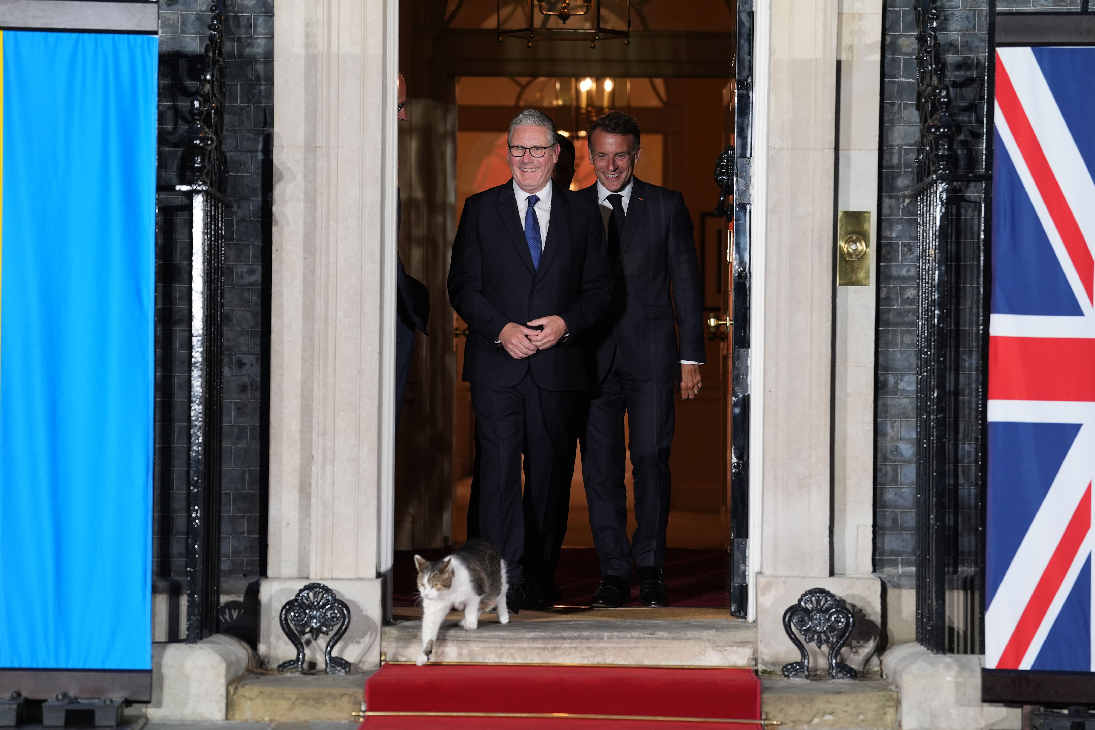 President of France Emmanuel Macron, and Prime Minister Sir Keir Starmer, laugh at Larry the Cat as they walk out for a photo at the door of number 10 Downing Street on Sunday June 7, 2026.