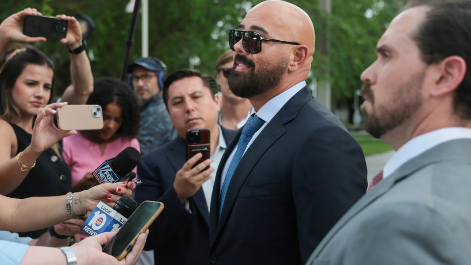 Joseph McBride, center, and Thomas Maniotis, right, co-counsel for Andrew and Tristan Tate, speak to reporters outside the C. Clyde Atkins United States Courthouse in Miami on Monday, July 20, 2026. The Tate brothers are scheduled to appear in federal court to face an extradition request from the United Kingdom on rape and sex trafficking charges. - Joe Raedle/Getty Images