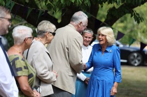 Queen Camilla wears Van Cleef & Arpels Lucky Spring butterfly clip at the Emmaus Norfolk and Waveney charity, which offers a home, work opportunities and support to people experiencing homelessness on July 20 in Bungay, England.