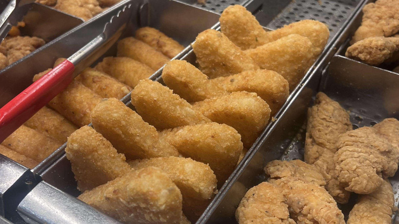 Row of Arby's potato cakes in a holding tray