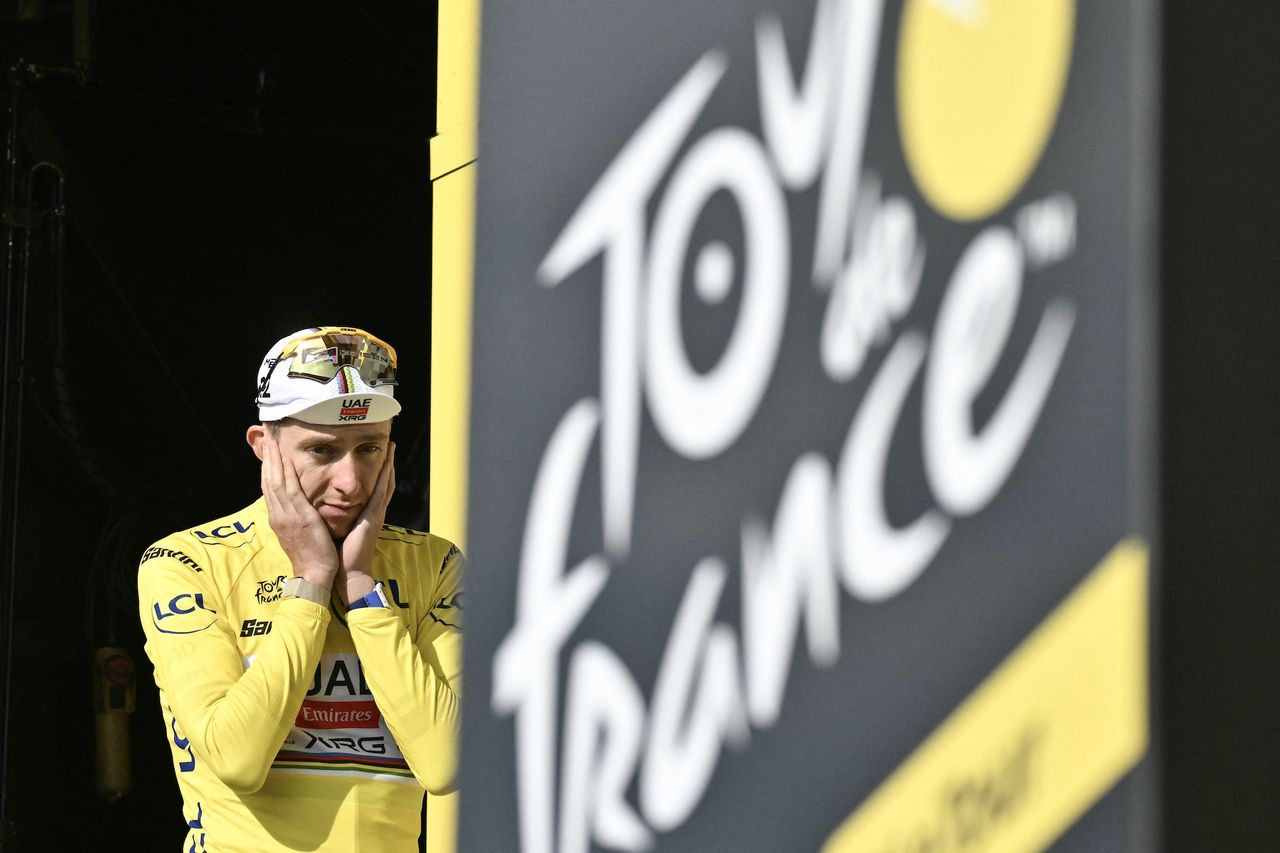 UAE Team Emirates - XRG's Tadej Pogacar celebrates on the podium with the overall leader's yellow jersey after stage 15