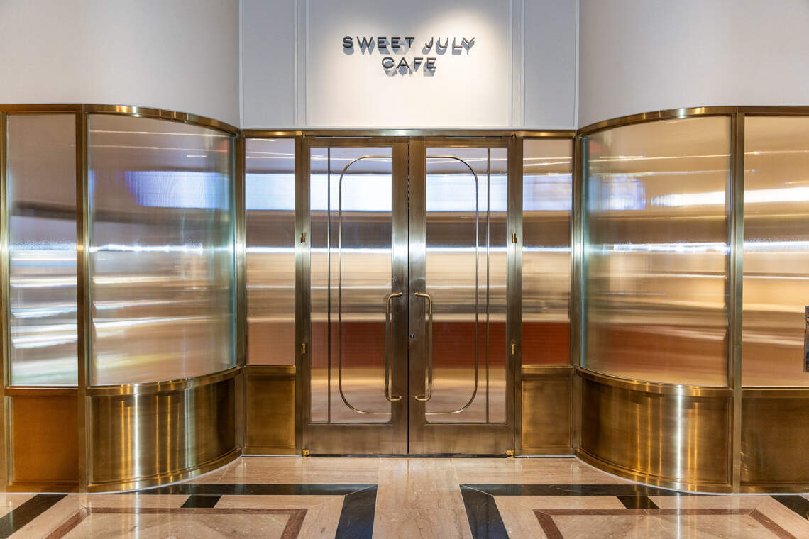 The front signage and entry for Sweet July Cafe in The Ritz-Carlton, Charlotte near the Trade Street main entrance.