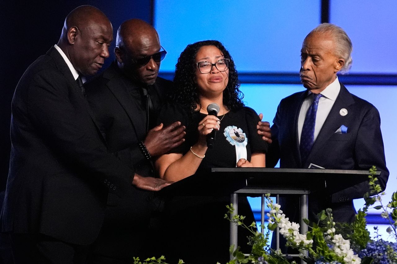 Christine Wonsley, center, is flanked by her husband Elmore, second from left, attorney Ben Crump, left, and Rev, Al Sharpton, right, during a memorial service for her son Nolan Xavier Wells, an 18-year-old found dead after taking a July 4 boat trip with friends, Monday, July 20, 2026, in Ocean Springs, Miss