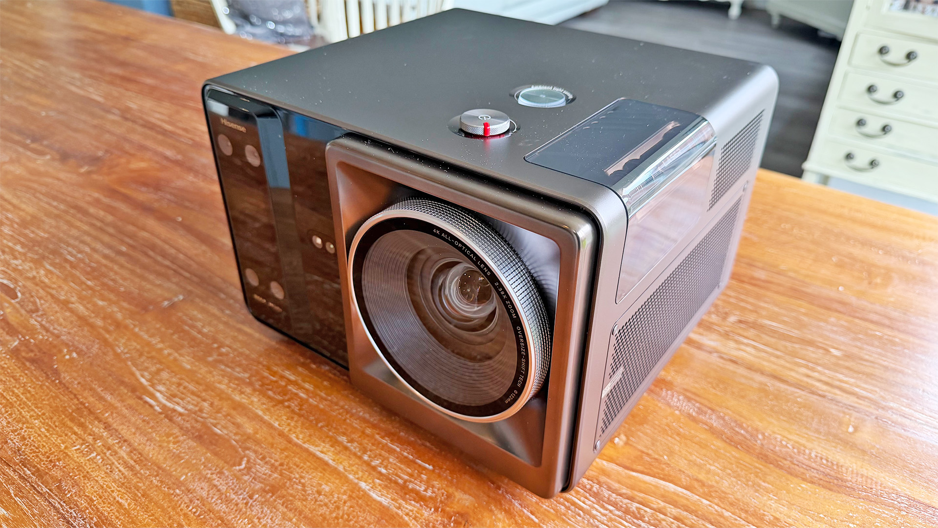 Hisense XR10 home cinema projector on wooden table