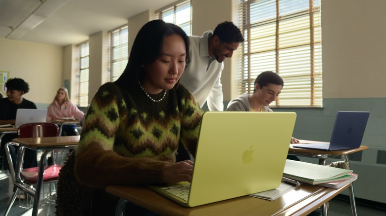 Students using MacBook Neo laptops in a classroom