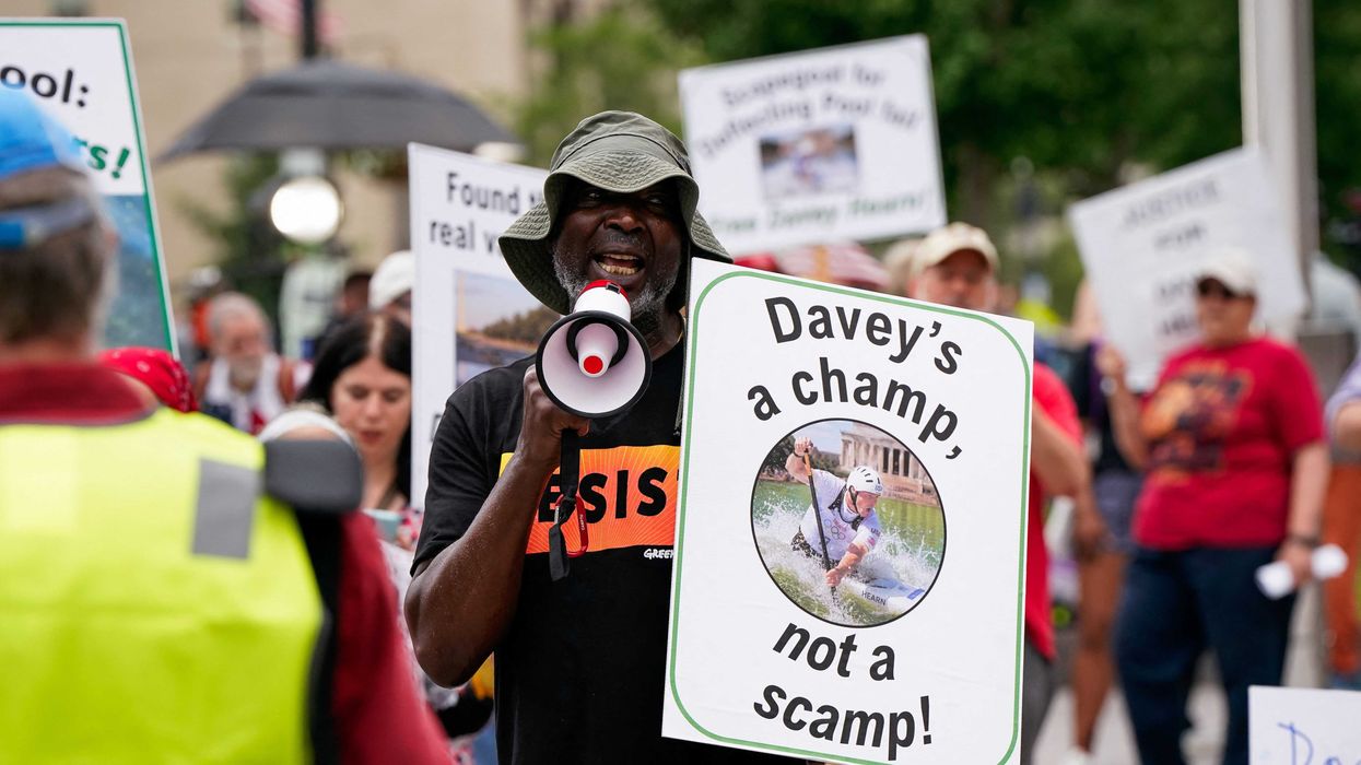 Supporters of former U.S. Olympic canoeist David Hearn hold signs ahead of Hearn’s arraignment on a felony destruction of property charge related to “vandalizing” the Lincoln Memorial Reflecting Pool, at DC Superior Court in Washington, D.C., U.S., July 9, 2026. REUTERS/Elizabeth Frantz