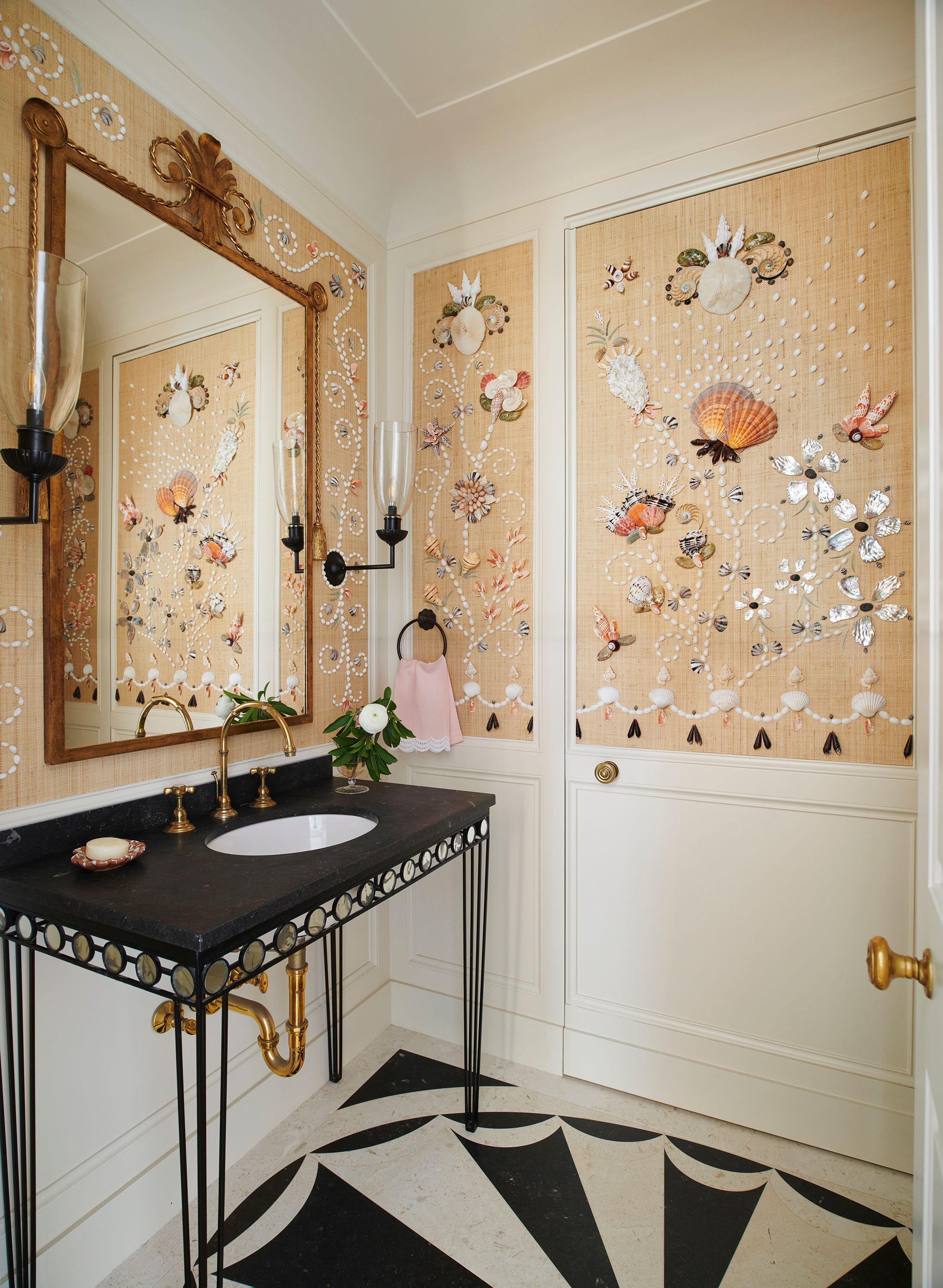 A whimsical shell assemblage by a local artist decorates the walls of one powder room, keeping the spirit of the first floor lighthearted.