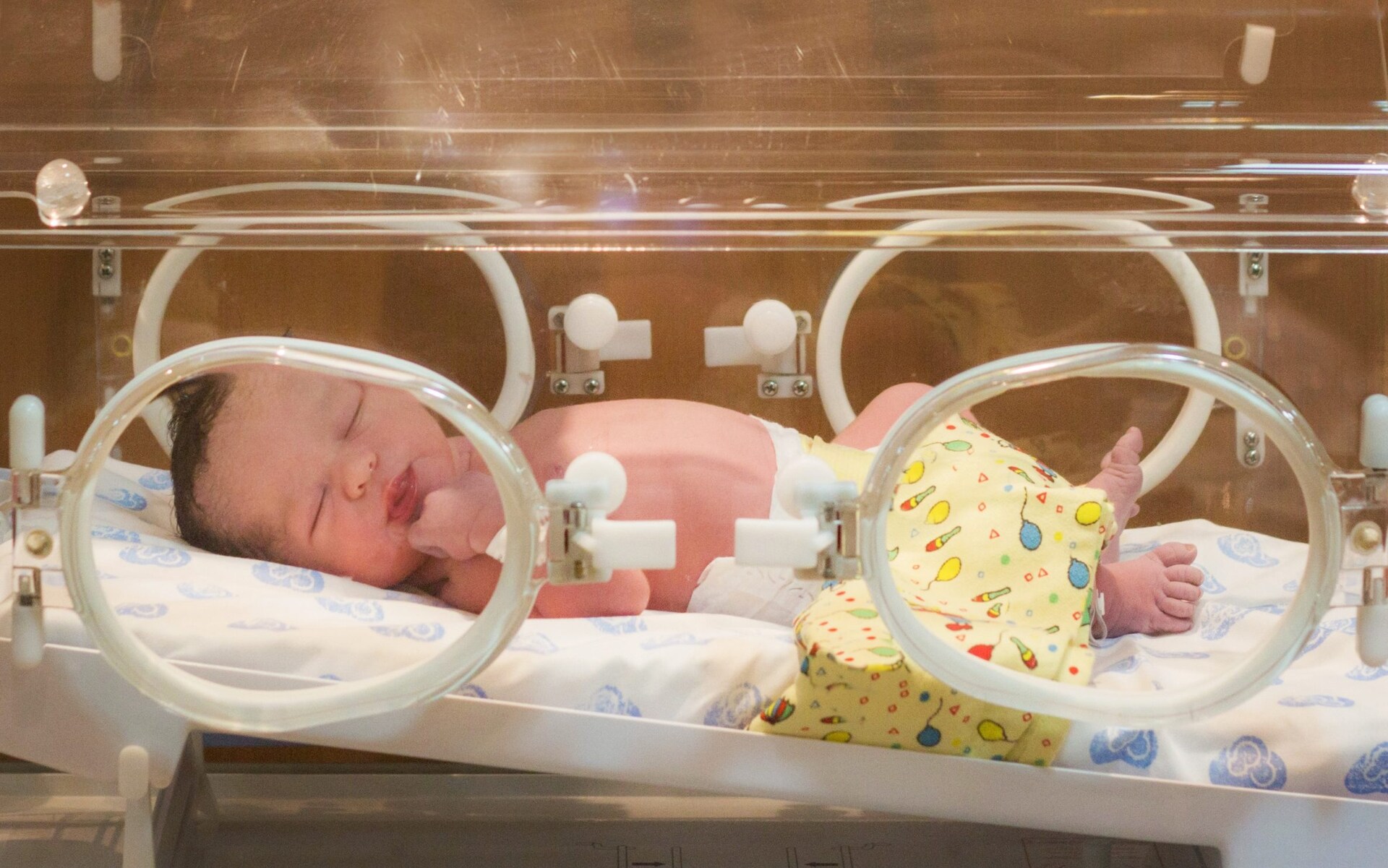 Newborn in a hospital incubator