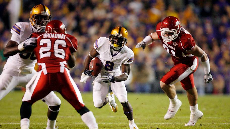 LSU Tigers wide receiver Trendon Holliday (8) runs up field past Arkansas Razorbacks defensive end Jake Bequette (91)