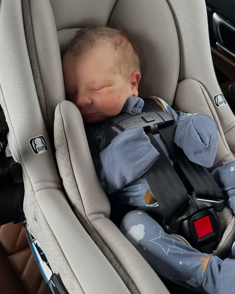 A sleeping baby in a car seat