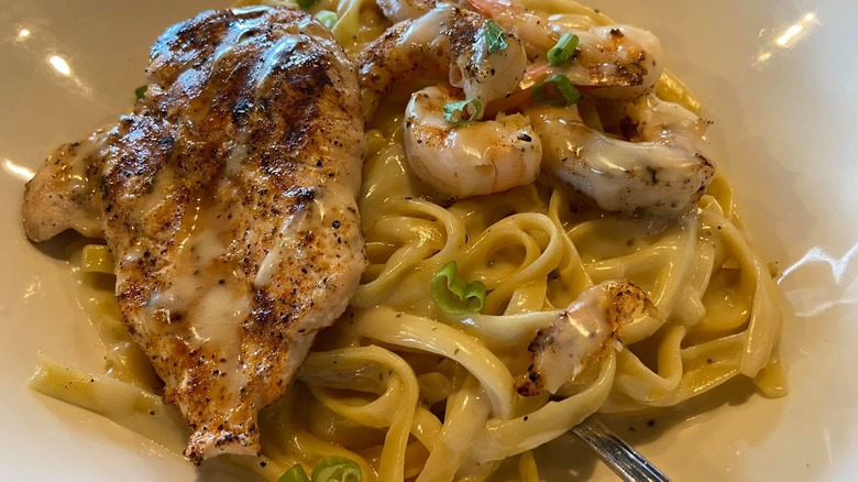 Queensland chicken & shrimp pasta dish at Outback on a white plate