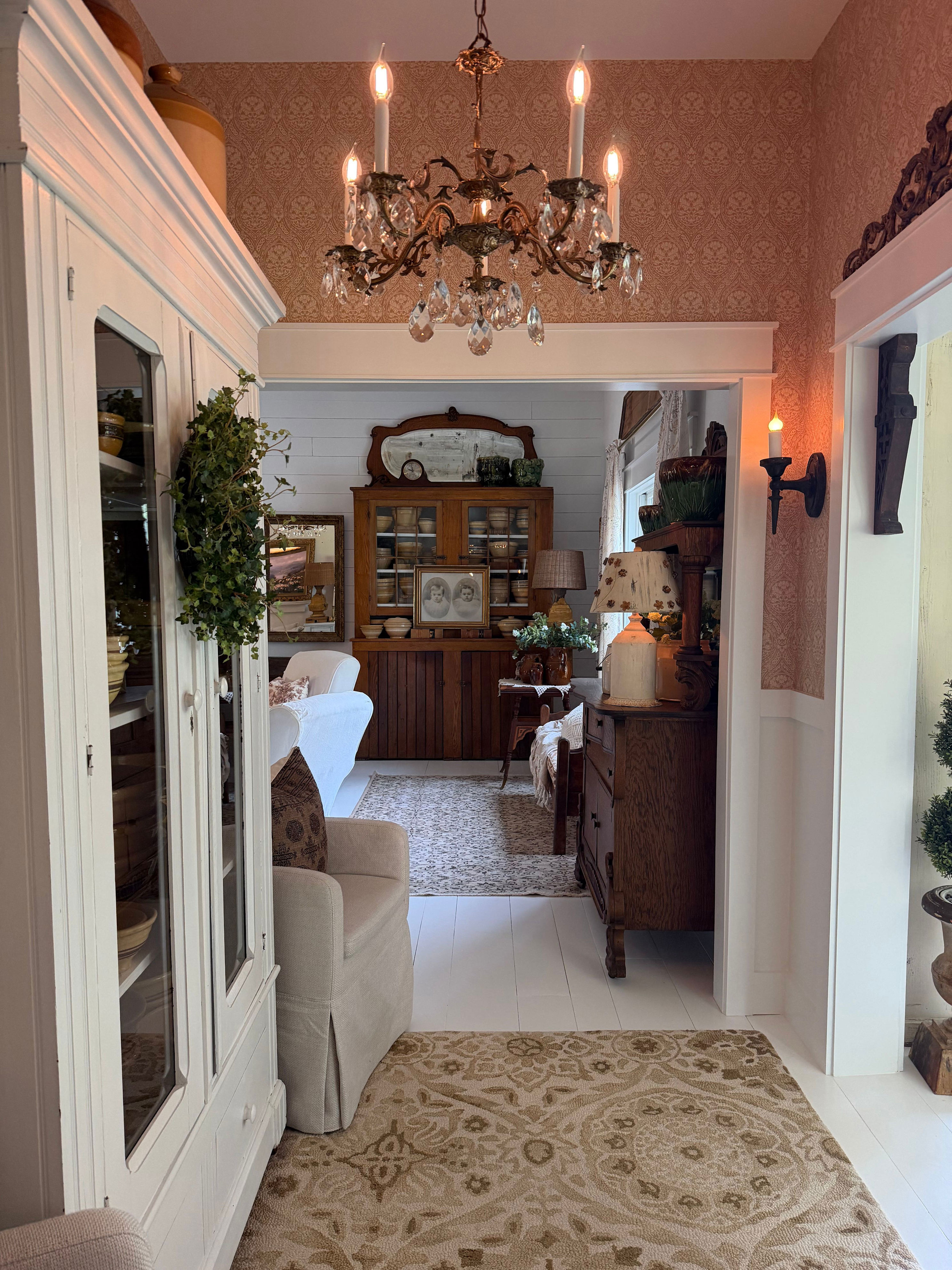 Vintage light fixtures, antique furniture, and historic-inspired features (like wide floor planks) help create the illusion of the home’s age.