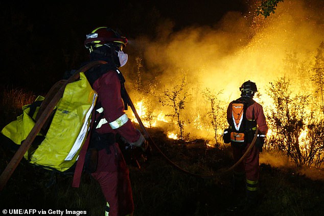 This handout photos released on July 19, 2026 by Spain's Military Emergencies Unit (UME) shows the military fighting a wildfire in La Mierla area, near Guadalajara, about 62 miles north of Madrid