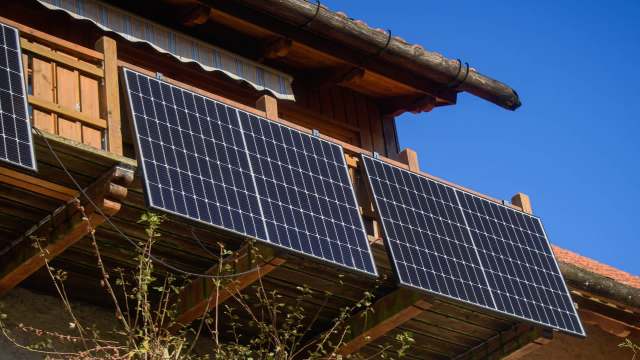 Solar panels mounted on a wooden balcony.
