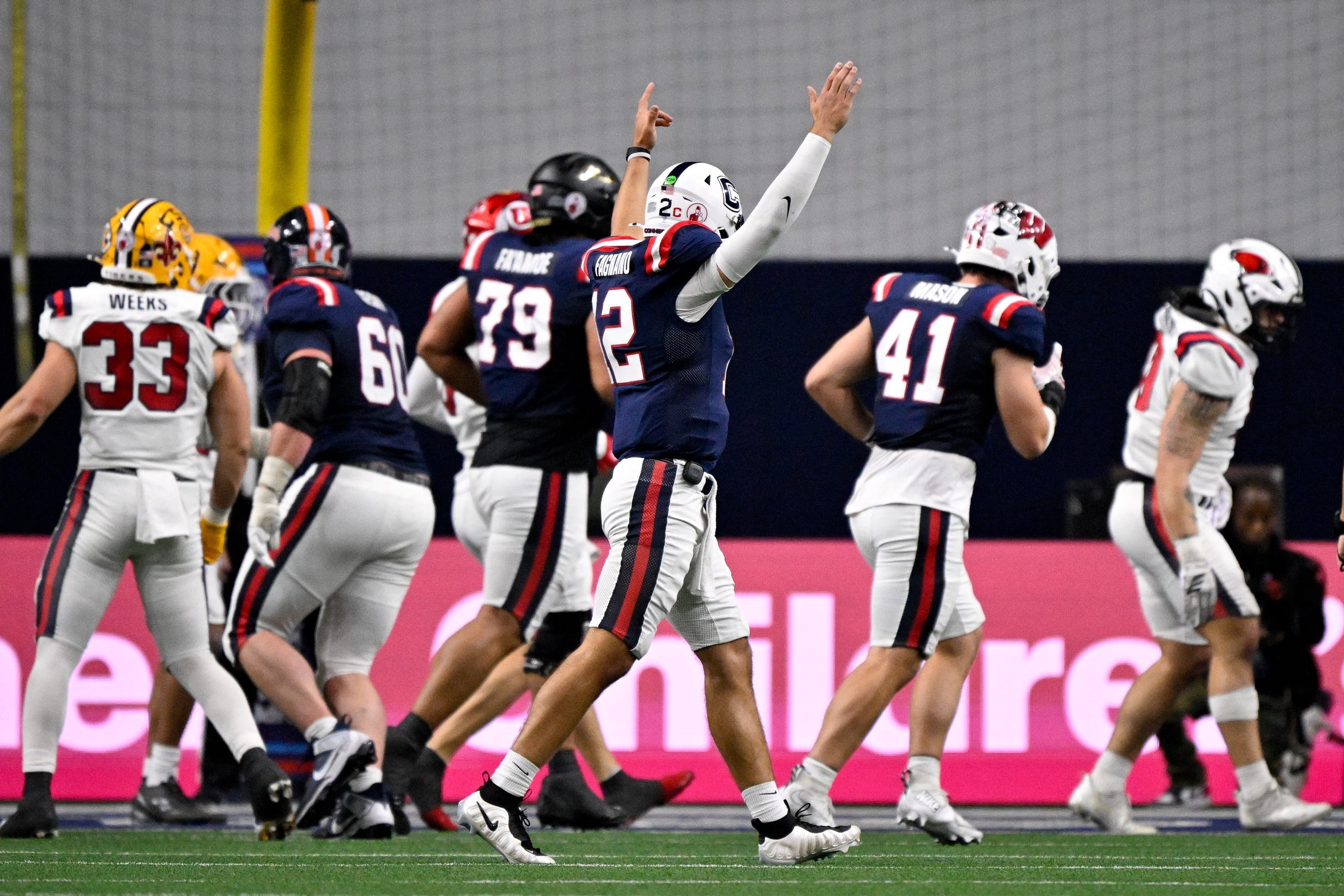 Jan 27, 2026; Frisco, TX, USA; West quarterback Joe Fagnano (12) celebrates after West scores a touchdown to take the lead over the East during the second half at the Ford Center at the Star. Mandatory Credit: Jerome Miron-Imagn Images