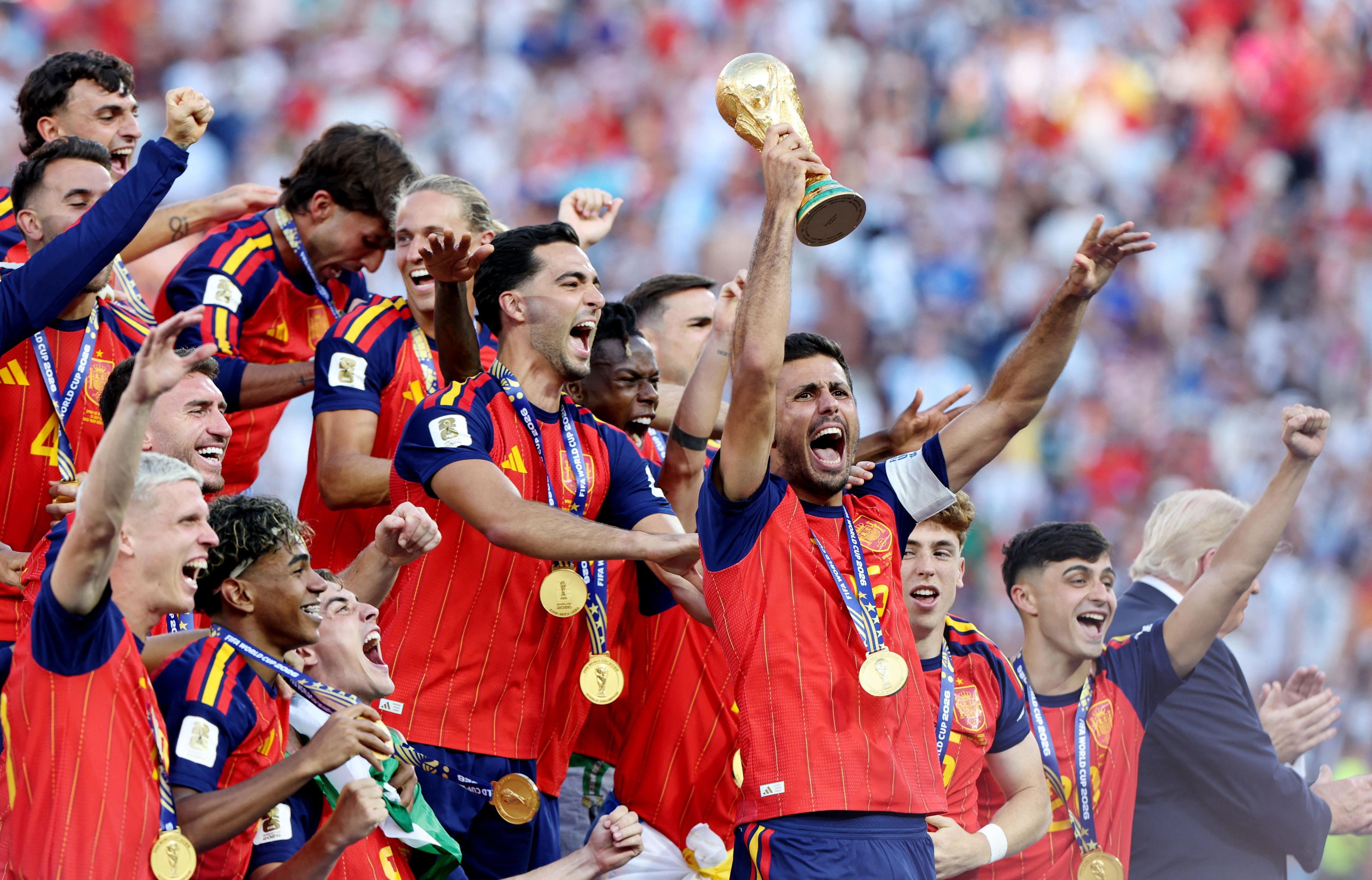 Spain's Rodri lifts the World Cup trophy alongside teammates as they celebrate winning the World Cup