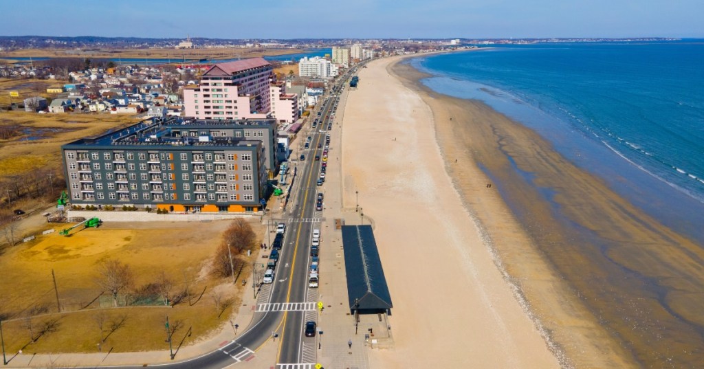 Revere Beach in Massachusetts is seen on a cold winters day where the beach is empty and the trees are bare, but the buildings crowding the beach remain.