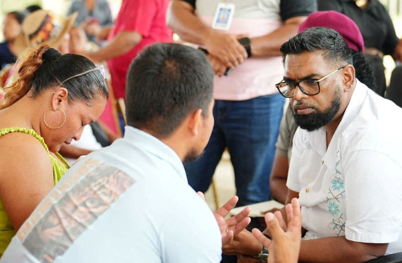Guyana's President Mohamed Irfaan Ali attends an event to meet with family members of victims of a ferry disaster, after the MV Barima, a ferry that was travelling from the capital Georgetown to the northwest village of Port Kaituma, capsized off the coast over the weekend. (credit: Guyana via Facebook/Handout via REUTERS)