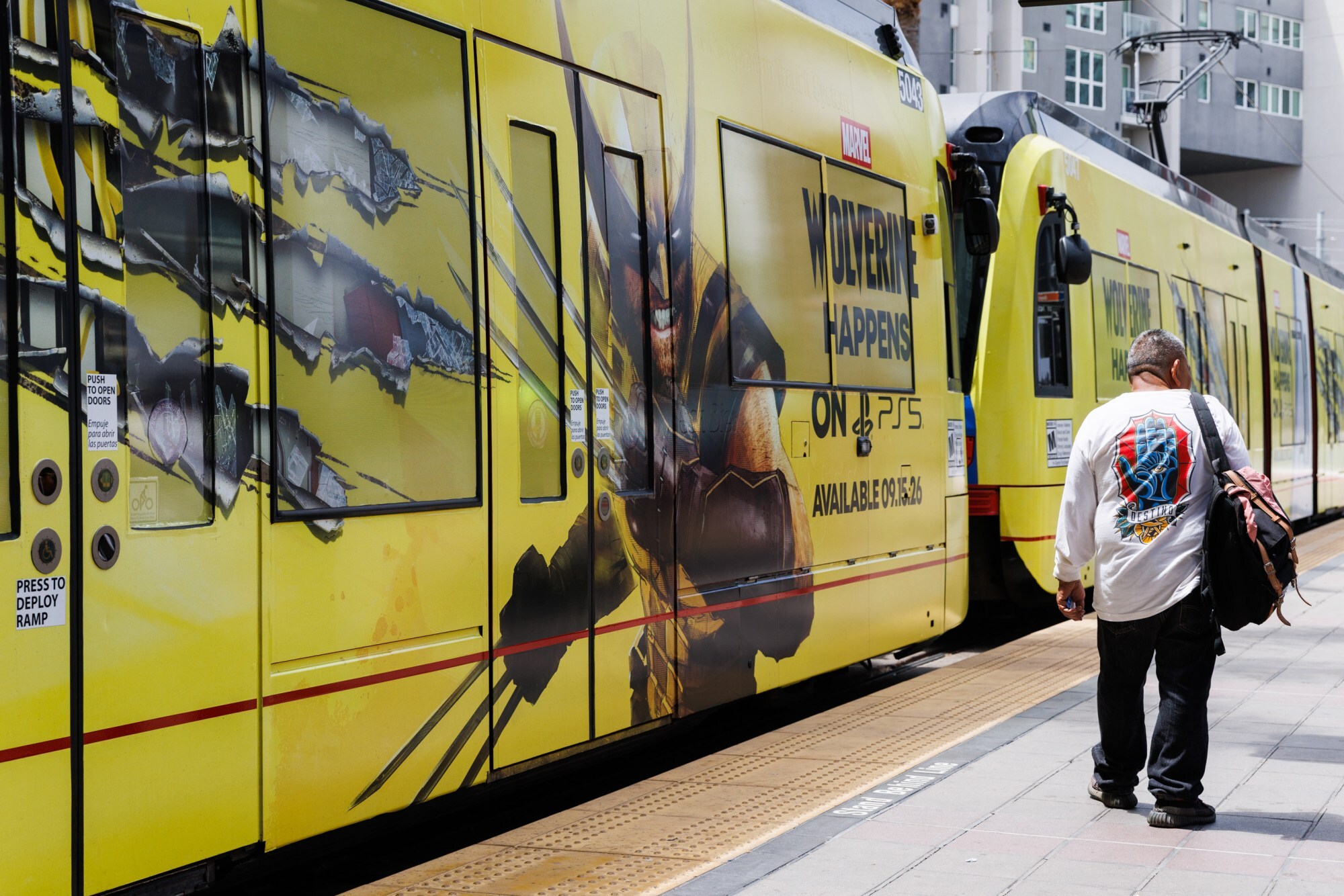 A trolley wrapped with an advertisement of the upcoming Wolverine video game arrives in downtown San Diego.