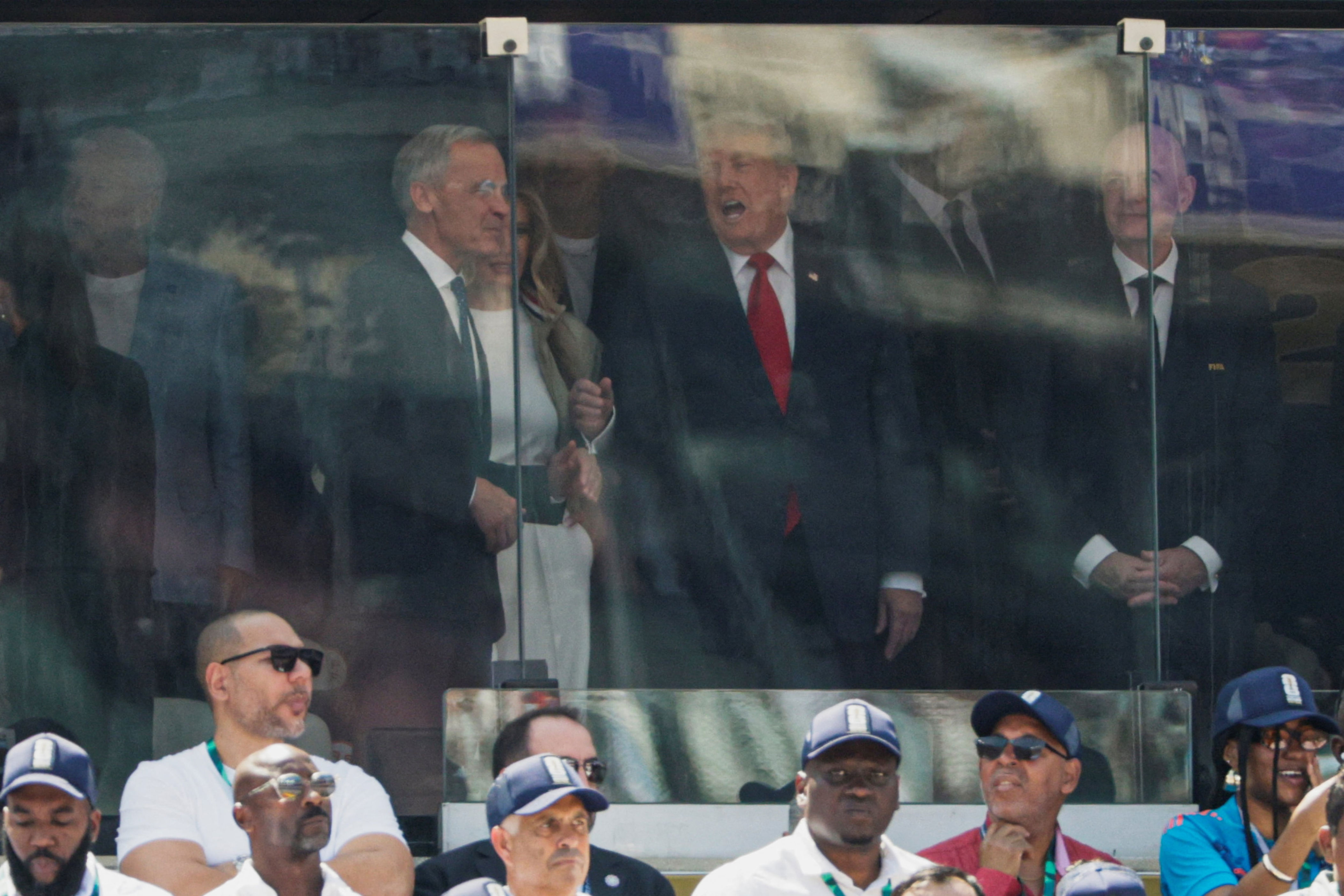 Trump and Carney were seen chatting in the VIP box at the World Cup game. Carney had declared in a video address in April, “Many of our former strengths, based on our close ties to America, have become our weaknesses, weaknesses that we must correct.” / Evan Vucci/REUTERS