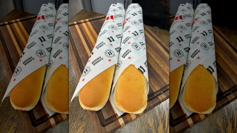 Two loaves of Jimmy John's bread on wooden board