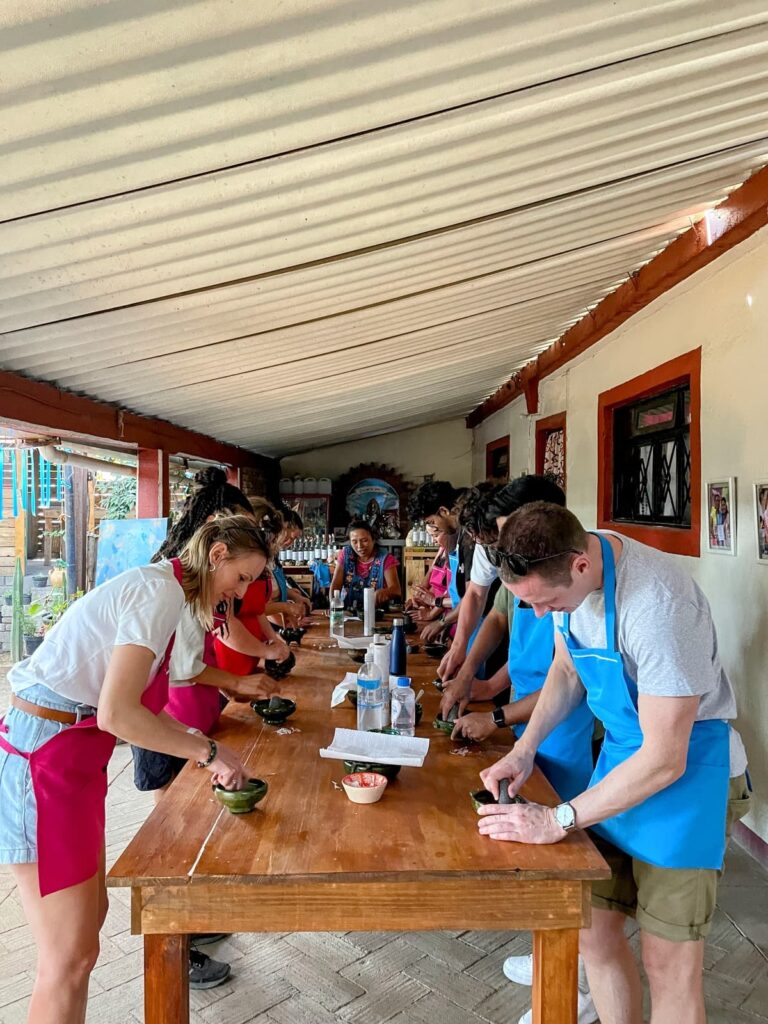 A group of people standing around a table preparing food