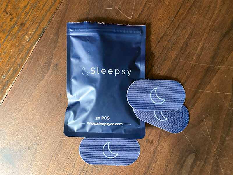 Sleepy patches in a navy blue pouch labeled